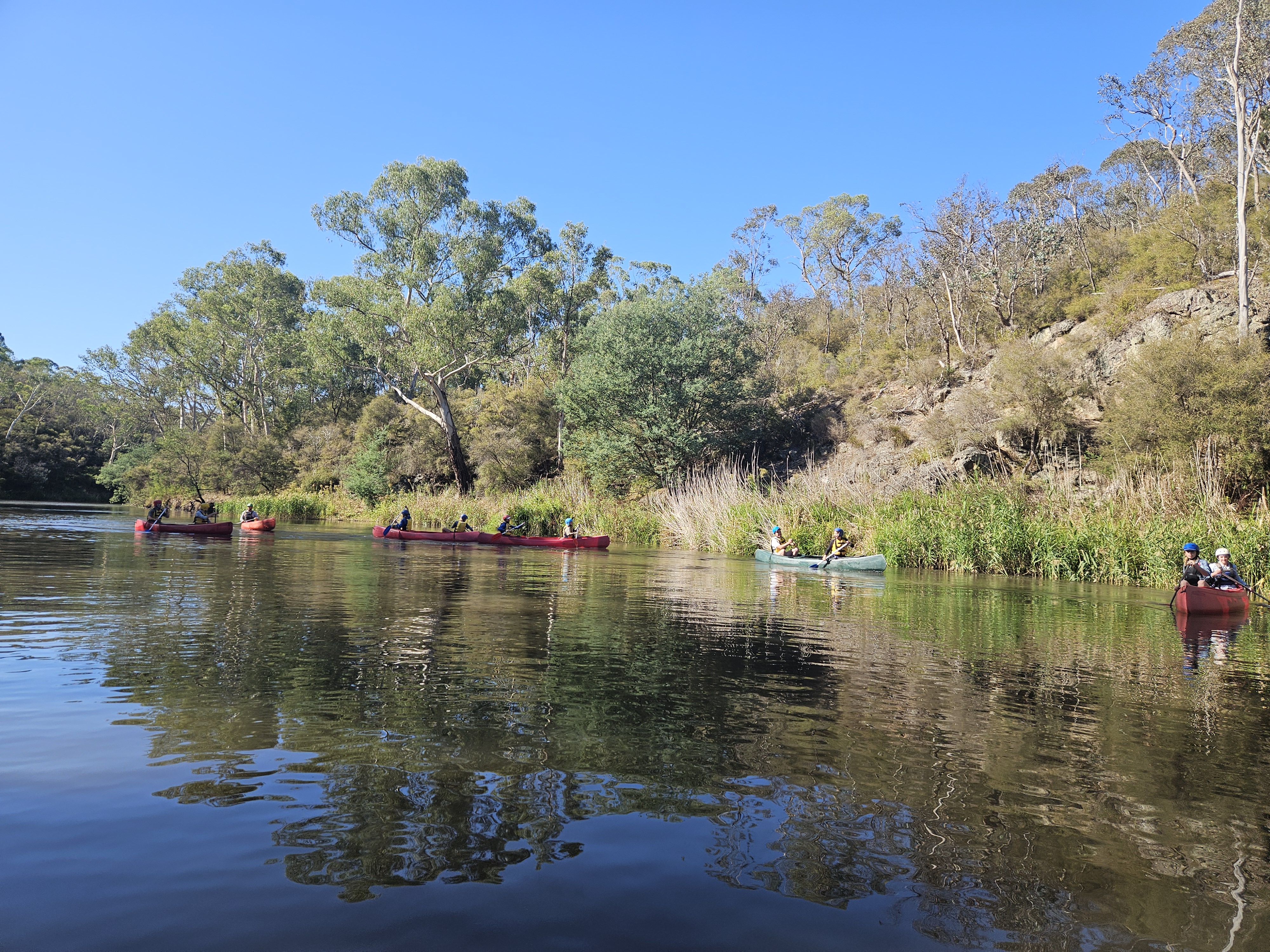 A group canoeing on the Yarra River